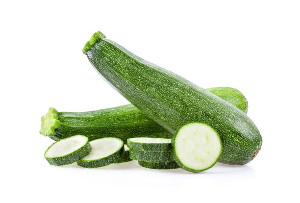istock fresh green zucchini with slice isolated on white background 1215707693