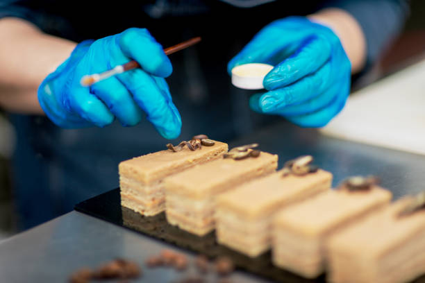 istock Confectioner makes a chocolate cake decorated with coffee grains 1215707969