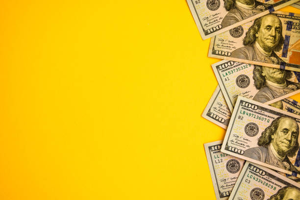 istock One hundred dollar banknotes on colored background top view, with empty place for your text business money concept 1215709571