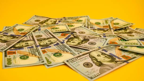 istock One hundred dollar banknotes on colored background top view, with empty place for your text business money concept 1215709664