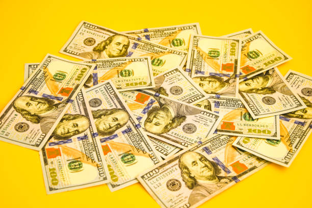 istock One hundred dollar banknotes on colored background top view, with empty place for your text business money concept 1215709672