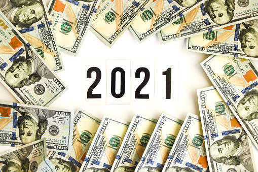 Budget 2021, the inscription on white space, on the background of dollar bills. New year budget concept. Business, planning businness
