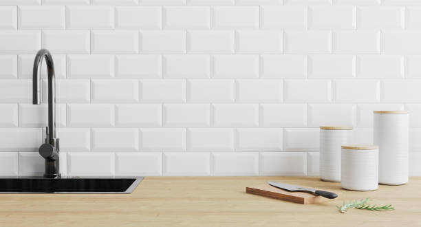 istock kitchen utensils gadgets near black sink on wooden surface and white tiled wall, kitchenware in kitchen concept, , knife on cutting board, modern home kitchen concept, 3d render 1215711405