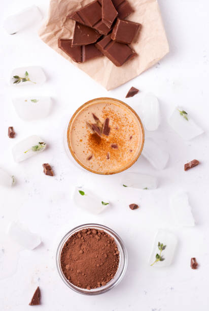 istock Lassi is a chocolate cold drink next to cocoa, chocolate and ice. 1215711605