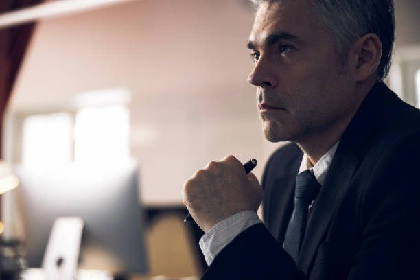 istock Caucasian man in suit working at computer indoors 1215711835