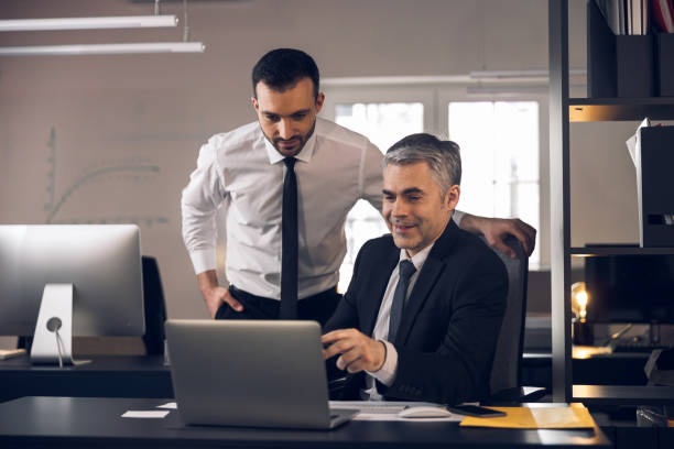 istock Caucasian men discusssing their tasks in office 1215711842