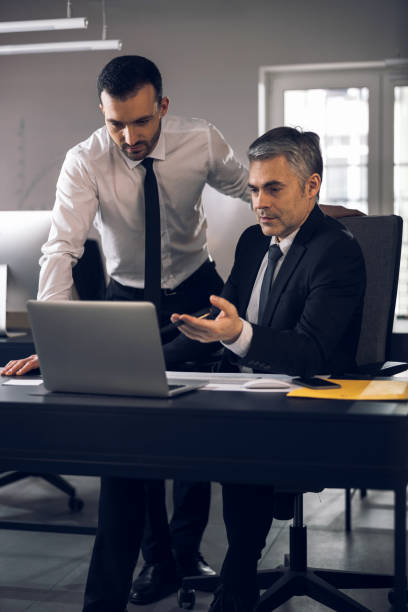 istock Caucasian handsome men discusssing their tasks in office 1215711844