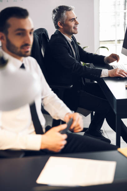 istock Caucasian men sitting at their workplace in office 1215711867