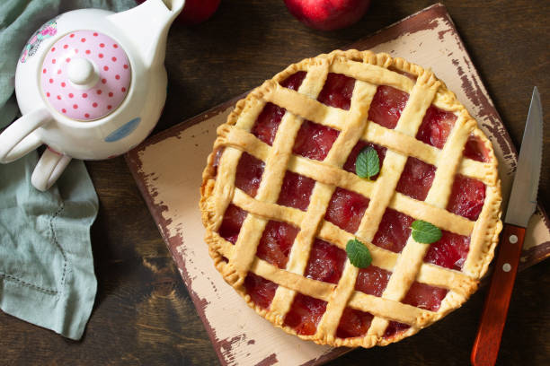 istock Homemade baking. Sweet apple pie on a rustic wooden table. Top view flat lay background. 1215714957