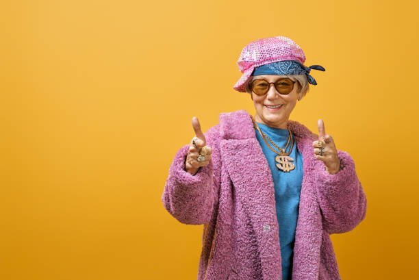 istock senior woman on color background 1215715387