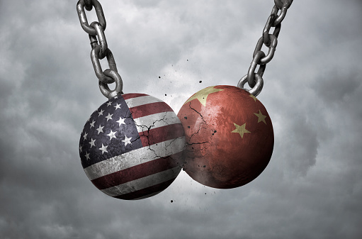 Two wrecking balls with american and chinese flags hitting each other, trade war concept