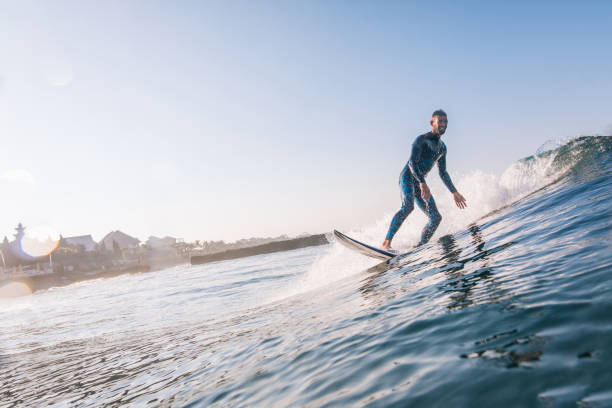 Young man surfing stock photo