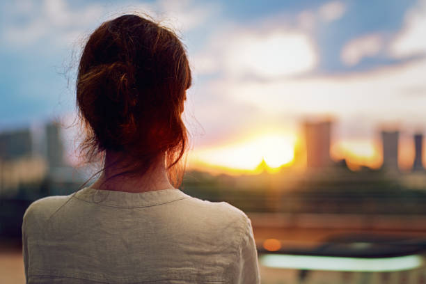 istock Young girl is watching sunset over Tokyo 1215716540