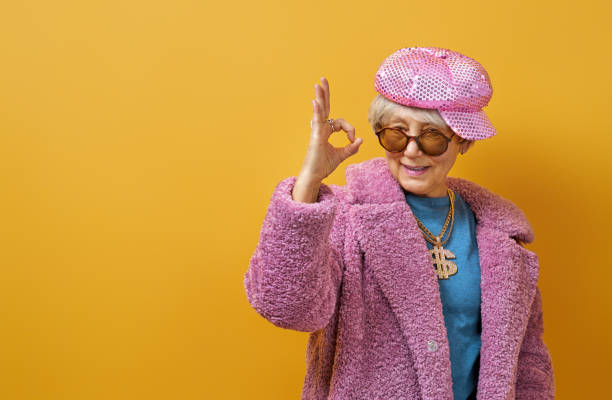 istock senior woman on color background 1215716818