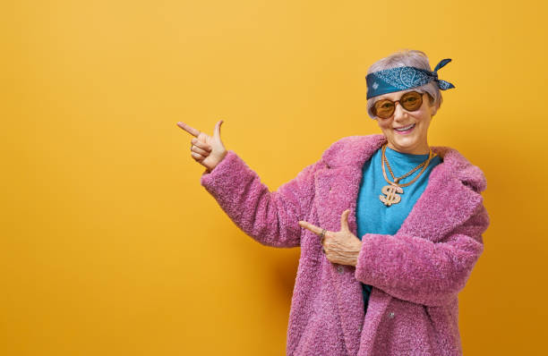 istock senior woman on color background 1215716893