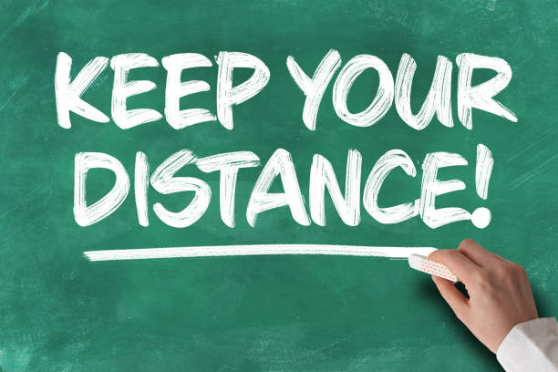 istock text KEEP YOUR DISTANCE written on green chalkboard 1215717364