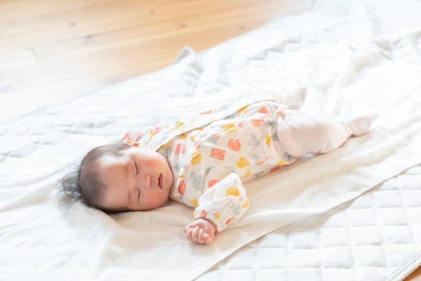 istock Cute baby sleeping soundly in a bright room 1215718506