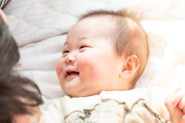 Dad comforting baby in bright room