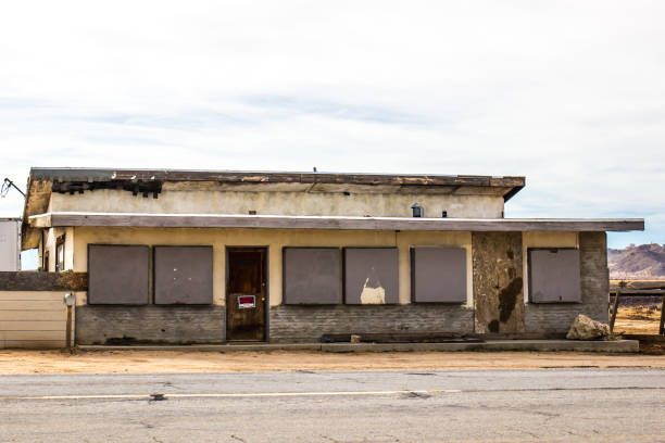 istock Abandoned Commercial Building With Boarded Up Windows 1215720834
