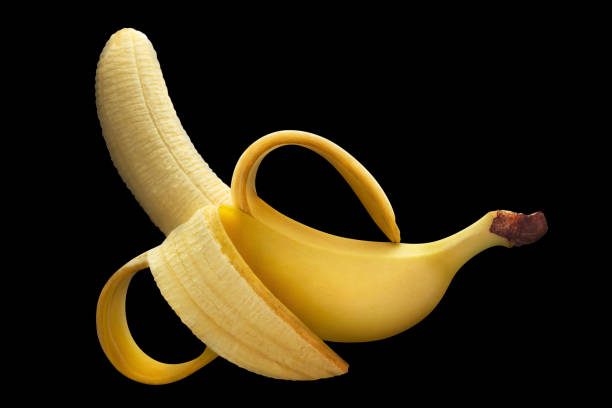 istock Half peeled ripe banana on black 1215721166