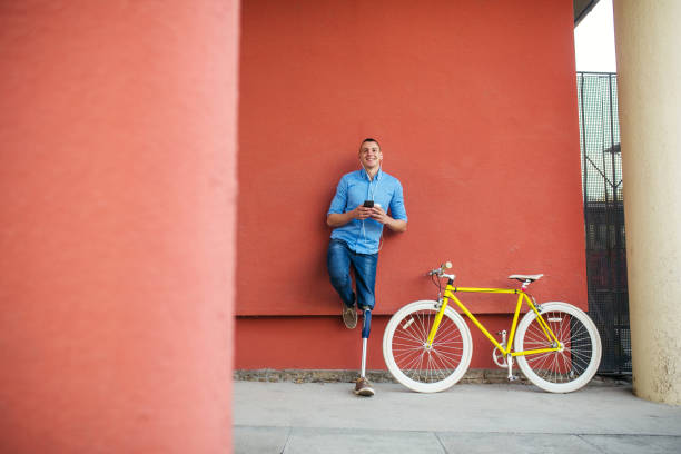 istock Young male with prosthetic leg standing next to bicycle 1215723435