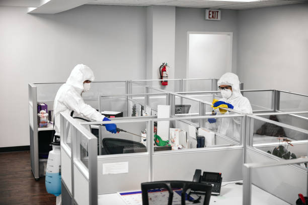 Cleaning And Disinfecting Office Two people in protective workwear cleaning and disinfecting offices. office cubicle mask stock pictures, royalty-free photos & images