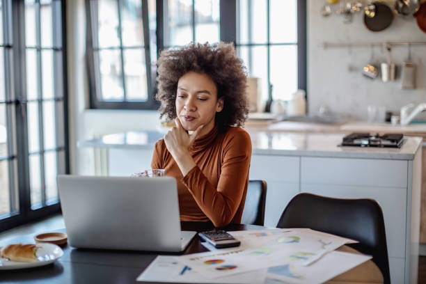 istock Beautiful young woman working from home 1215726036