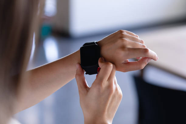 istock Focus on digital watch wearing by a woman 1215728098