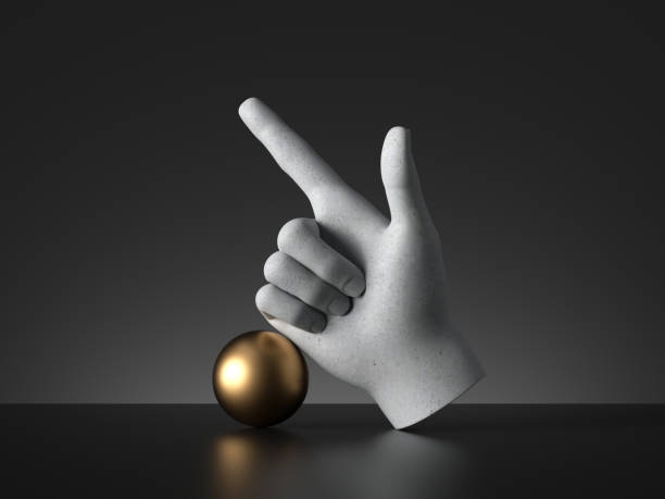 istock 3d render, mannequin hand finger pointing up and golden ball, direction gesture, isolated on black background, minimal fashion concept, simple clean design. Human limb prosthesis. Sculpture art object 1215729448
