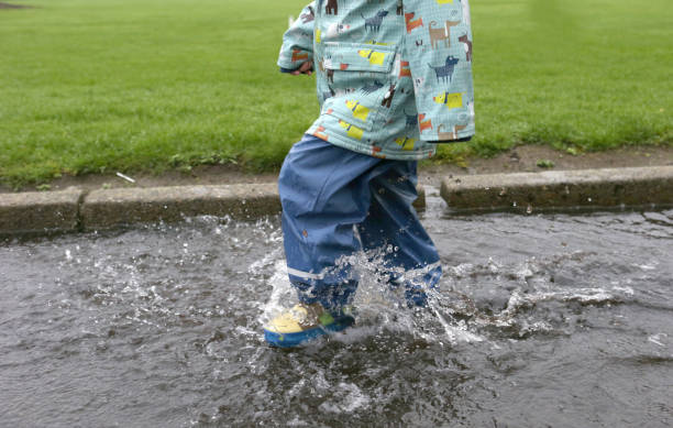 istock A child or kid walking through water. 1215732081