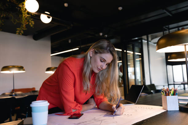 istock Architect Caucasian woman working on her sketches 1215732506