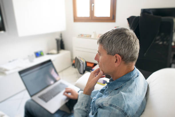 Businessman using laptop while sitting on sofa