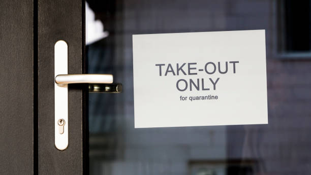 istock Announcement on the door about working in the mode Only take out only during quarantine 1215733829
