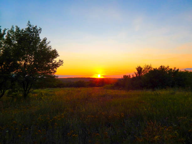 istock sunset on a summer evening with red sky 1215734058