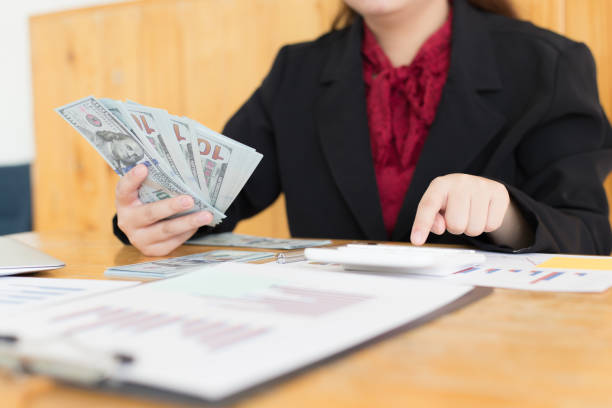 istock Data analysis, Financial accountants are evaluating company revenue data using calculators and databases to compute and summarize for leaders, Young women working. 1215734079
