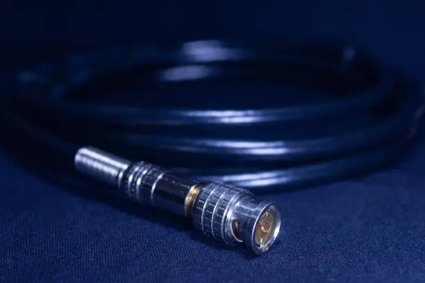 BNC CONNECTOR BLACK COAXIAL CABLE BAYONET NEILL CONCELMAN CONNECTOR IN BLACK BACKGROUND TELE COMMUNICATION