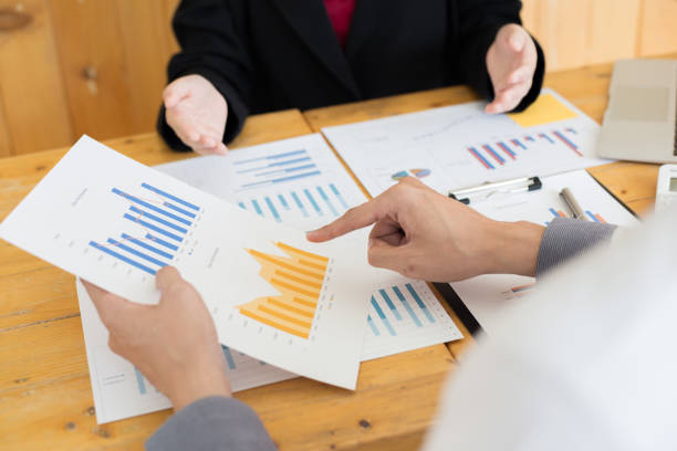 istock Financial and investment planning, Head of Marketing is analyzing data from the summary graph statistics for executives, business meetings. 1215734156