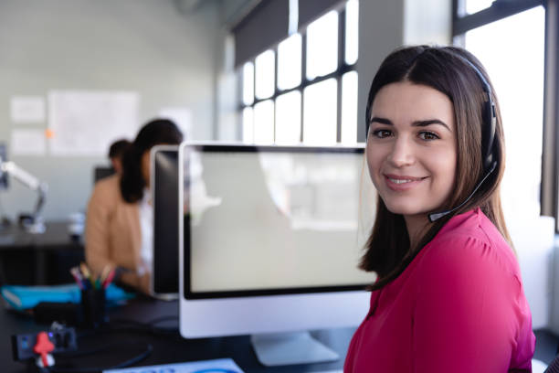 istock Caucasian woman working with headset phone in office 1215734239