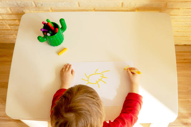 istock boy draws with felt pen in the album 1215734689