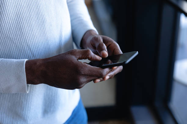 istock African American man using his phone 1215734767