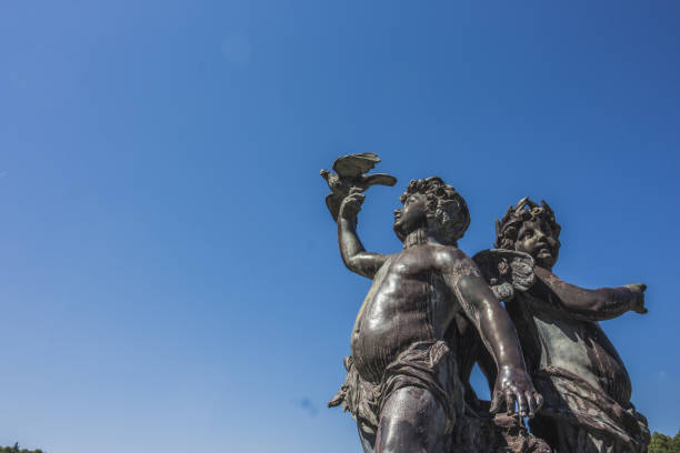 istock Angels statue and blue sky, Sculpture of cupid 1215735825