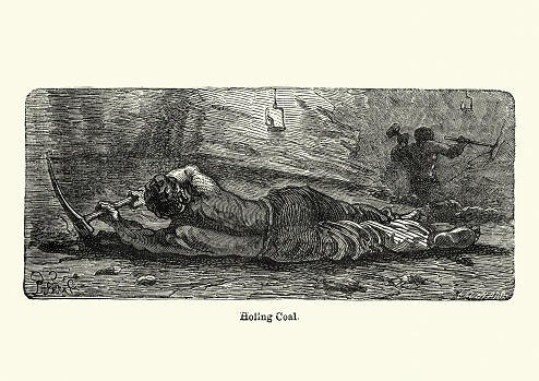 Vintage engraving of a Victorian miner laid on his side holing coal, 19th Century. Holing is the undercutting in a bed of coal in order to bring down the upper mass