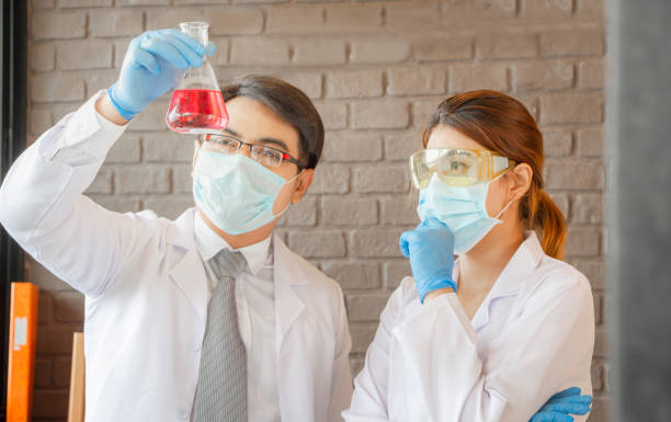 istock Scientist team looking at test tube making research in clinical laboratory 1215736089