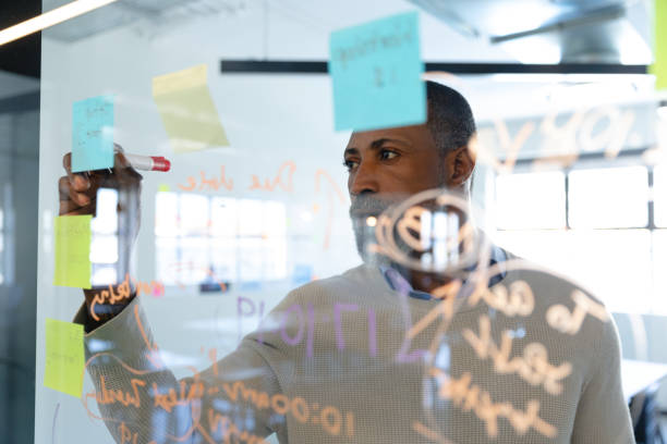 African American man writing on sticky notes