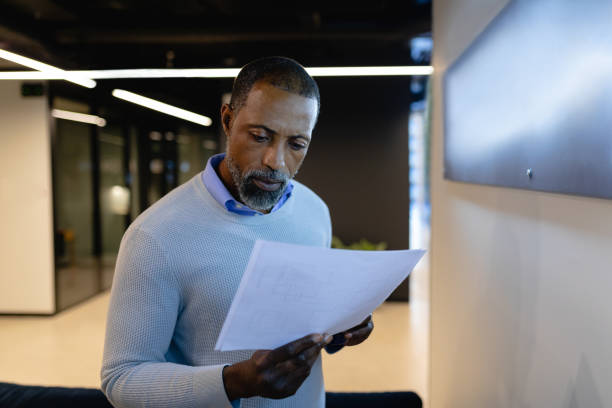 istock African American man reading papers in office 1215736172