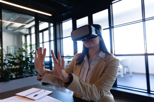 istock Caucasian woman using virtual reality in office 1215736383