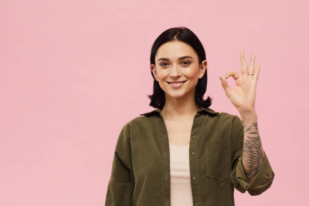 istock Young Woman Showing OK 1215736710