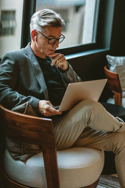 istock Businessman looking busy working on laptop 1215737991