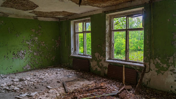 istock Chernobyl exclusion and radioactive zone. Abandoned ghost building. Broken windows. Chernobyl history of tragedy. Industrial catastrophe concept. 1215738253