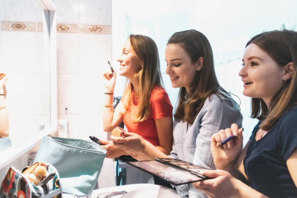 istock three young woman refreshing make up in bathroom 1215738583